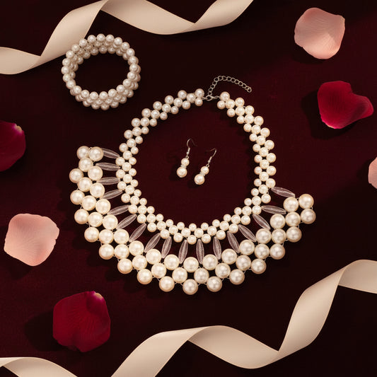 Pearl necklace and earrings on a brown surface with a white shell