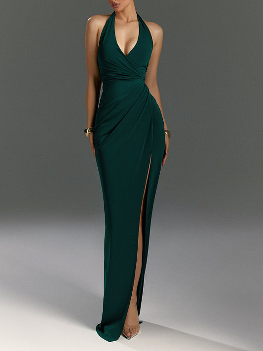 Green evening gown with a high slit on a gray background