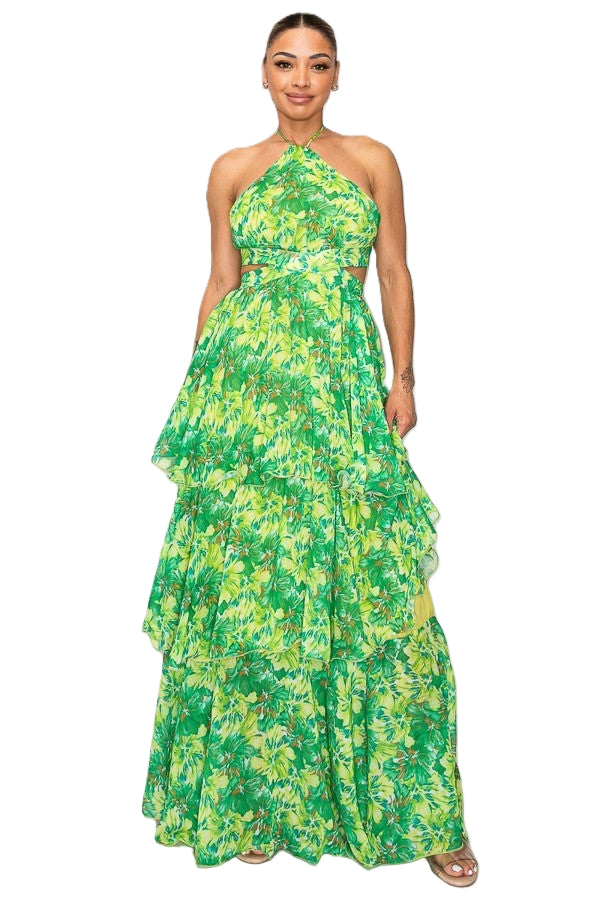 Woman wearing a green floral halter neck gown on a white background