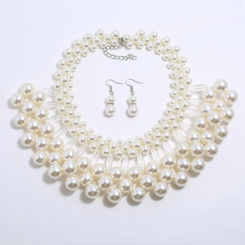 Pearl necklace and earrings set on a white background