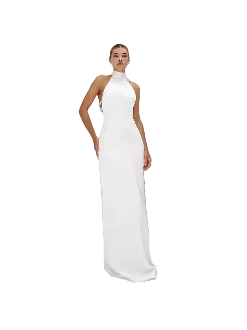 Woman wearing a white halter neck gown on a plain background