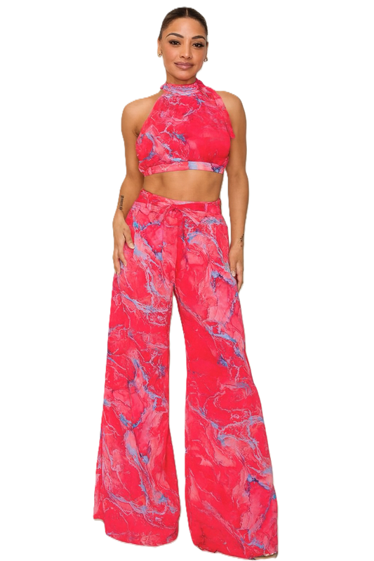 Woman wearing a pink and blue patterned outfit on a white background